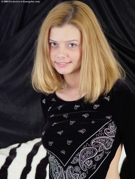 Stunning american blonde teen Jessica Cooper removes a black dress before toying her pussy