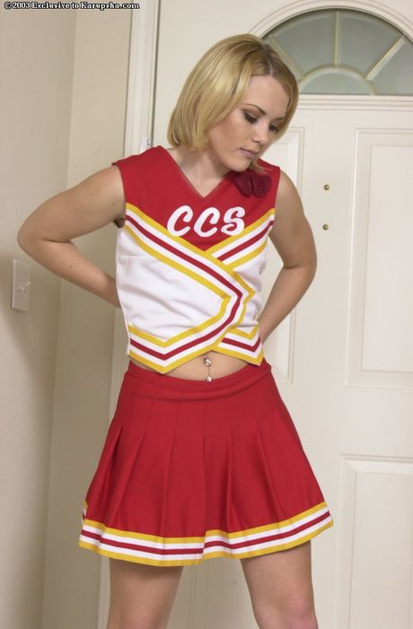 Cute cheerleader Keera strips to show her small tits and her shaved pussy