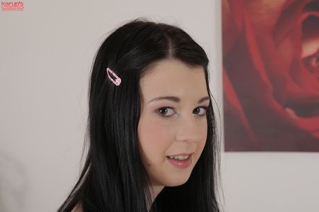 Dark haired teen Sarah Lollypop finger spreads her pink pussy on a sofa