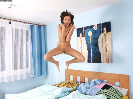 Nude ukrainian beauty Monika Benz finger spreads her pussy on a bed in solo action