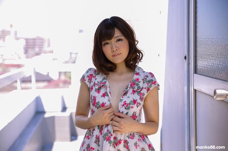 Brown-eyed Japanese babe Tomoka Sakurai reveals her large boobs and masturbates