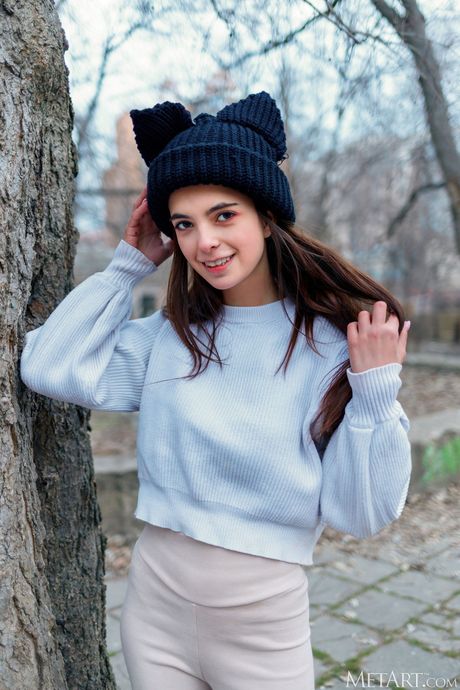 Lean teen Neesa gets naked in a public place while sporting pigtails