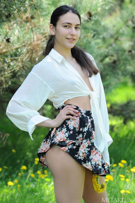 Russian belle Cira Nerri gets naked in a meadow and shows her tiny tits & ass