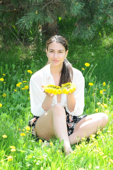 Russian belle Cira Nerri gets naked in a meadow and shows her tiny tits & ass