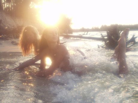 Intriguing teen babes with beautiful eyes and sexy bodies posing naked on the beach