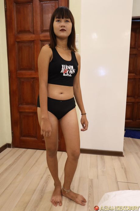 Asian beauty Ha B strips down on a bed before spreading her pussy