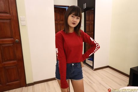 Asian beauty Ha B strips down on a bed before spreading her pussy