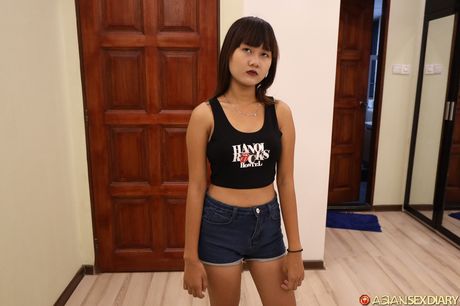 Asian beauty Ha B strips down on a bed before spreading her pussy