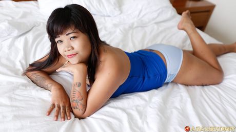 Tat-Covered babe Angely demonstrates her amazing juggs and spreads her hairy pussy