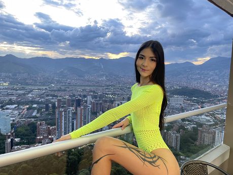 Dark haired teen Jana Red takes off her lingerie before a nude modelling gig