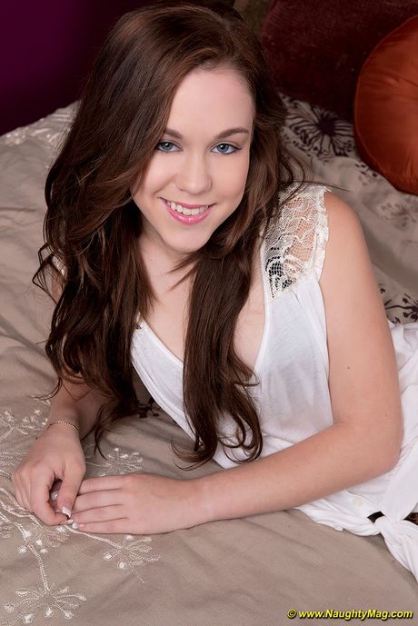 才華橫溢的美國女孩 Trinity Rae 用手指在床上張開她的粉紅色陰部