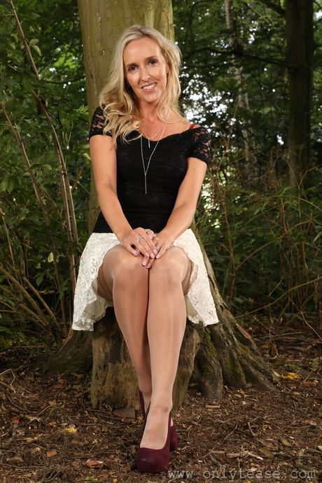 Light-Haired british girl Bex White takes off her clothes in a backyard