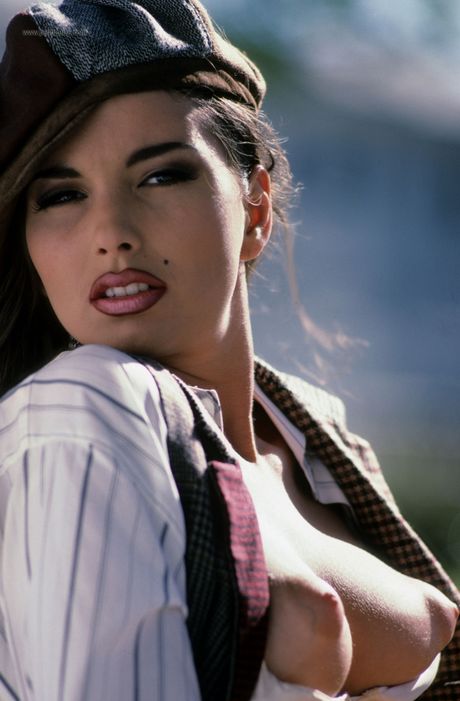 Sexy brunette with natural tits Sabrina West exhibits her hot body outdoors