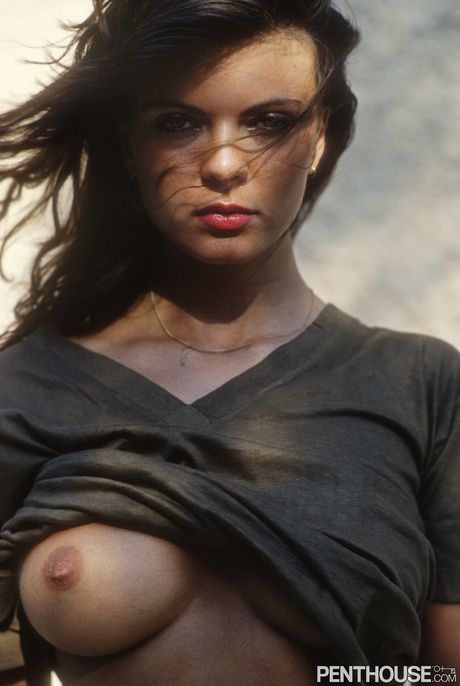 Brunette babe Julia Perrein highlights her big tits and hairy pussy outdoors