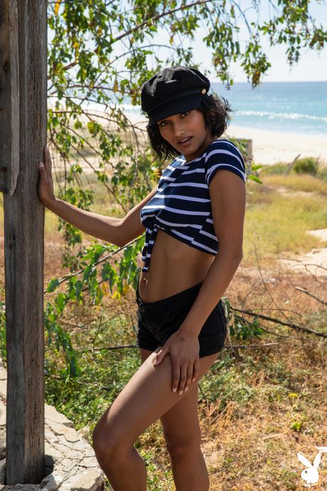 First-Class indian brunette Angel Constance gets naked on a beach in a baseball cap