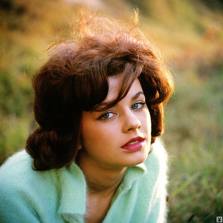 Red-haired covergirl Nancy Nielsen demonstrates her massive tits and poses outdoors