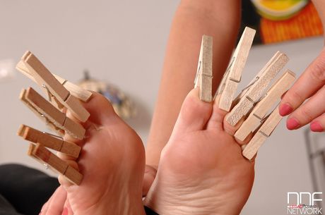 Blonde cougar Zuzana Z. whips her Asian slaves feet with a cane