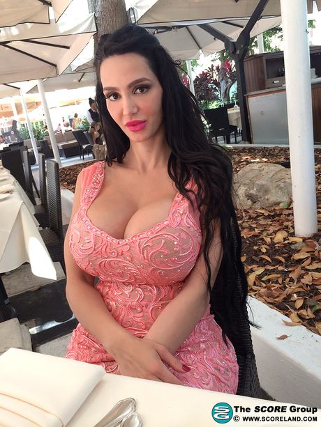 Brunette Amy Anderssen unveils her amazing racks and poses in a solo