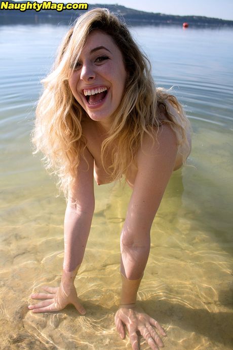 Inviting blond hottie Camille bares big knockers and sexy butt at beach