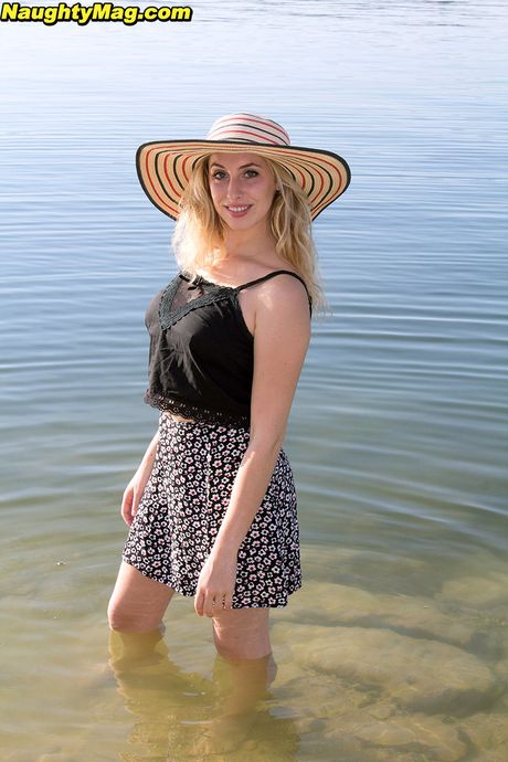 Enticing cutie Camille in sexy skirt exposing big knockers and hot ass on the beach