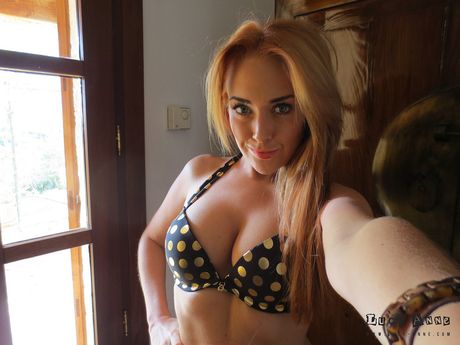 Blonde czech stunner Lucy Anne highlights her huge tits and ass before getting naked