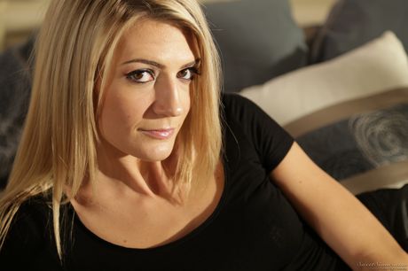 Hot american blonde Amanda Tate gets naked before masturbating on a sofa