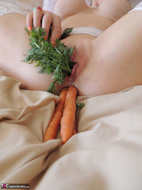 Mature british blonde Emerald toys her pussy and asshole in white stockings