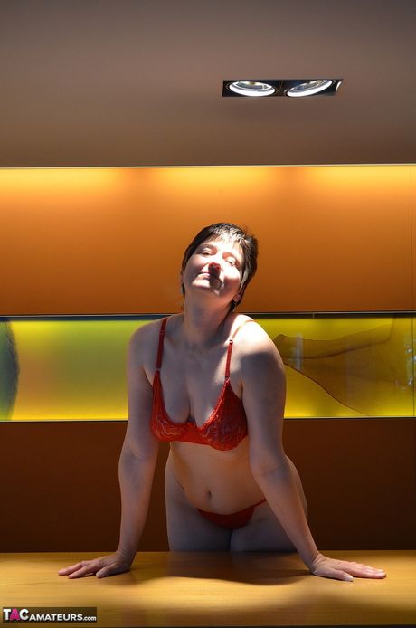 Nice german mature Hot Milf strips to her boots and presents her huge tits