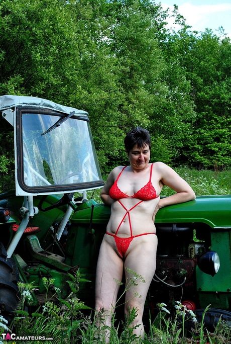 Stunning german Milf Hot Milf strips to her red lingerie and poses on a tractor