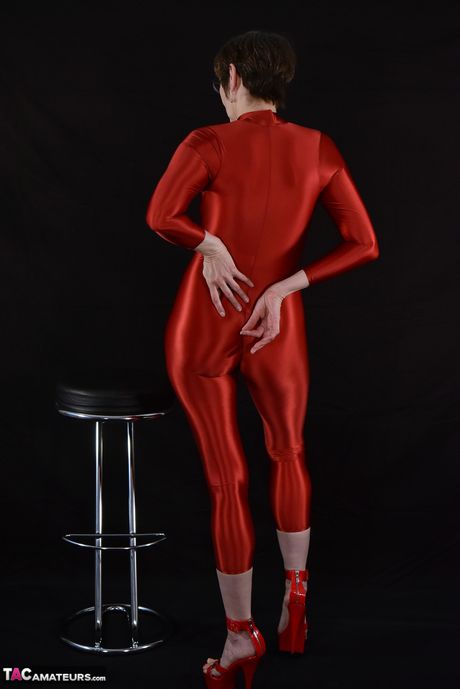 Adult german lady in latex suit revealing her tits and pussy in the studio