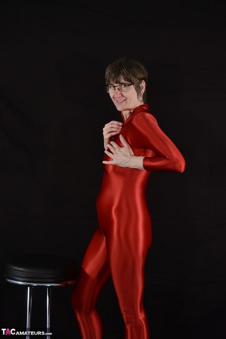 Adult german lady in latex suit revealing her tits and pussy in the studio