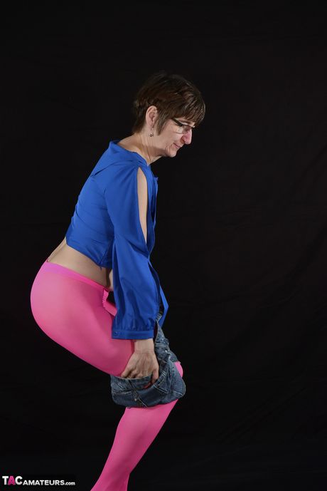 Hot german mature lady in glasses strips to show her small tits and bald pussy