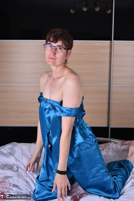 Devastating german mature lady in glasses stripping and spreading her legs