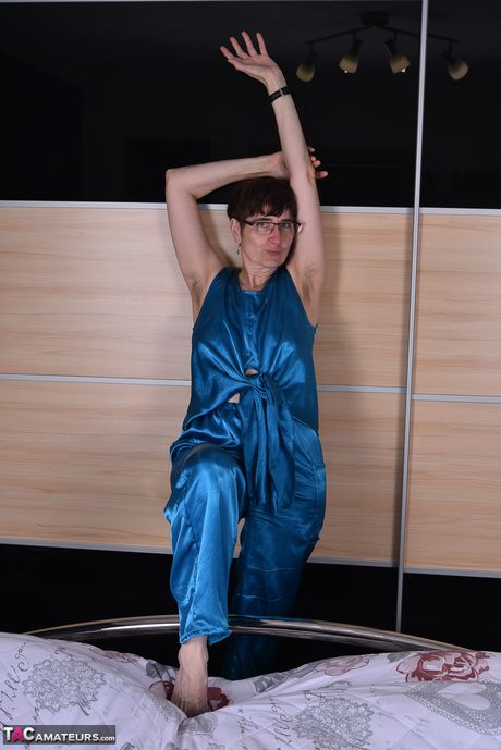 Devastating german mature lady in glasses stripping and spreading her legs