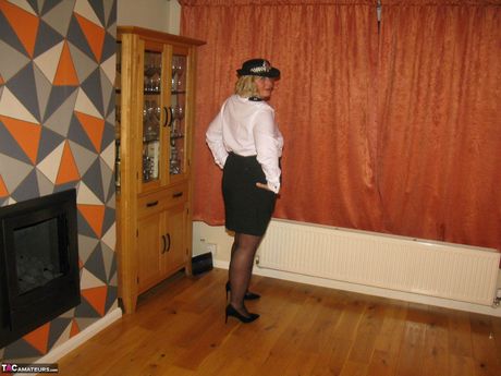 Light-Haired british mature Chrissy Uk strips to her stockings and poses in a uniform