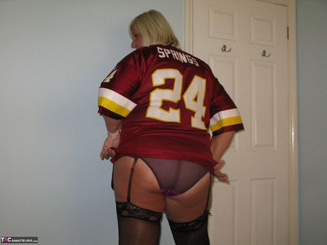 Mature british blonde Chrissy Uk reveals her amazing juggs and ass before posing in stockings