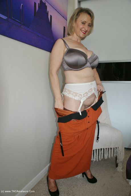 Mature british blonde Sugar Babe toys her pussy in a hot garter belt