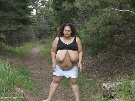 Curvy Baby Girl strips and highlights her big racks in the countryside