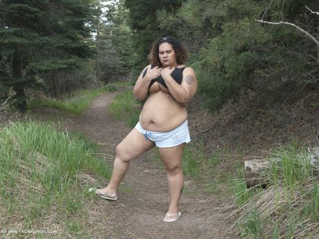 Curvy Baby Girl strips and highlights her big racks in the countryside