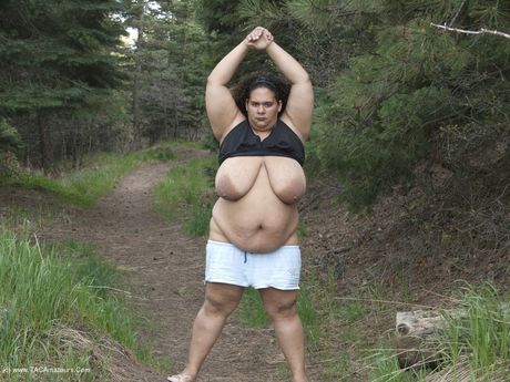 Curvy Baby Girl strips and highlights her big racks in the countryside