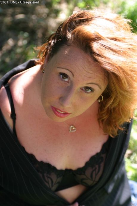 Mature blonde Charlie shows her big melons and poses in a solo