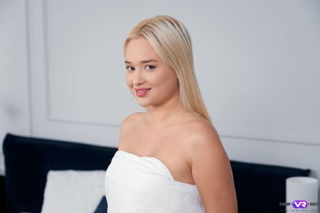 Blonde russian cutie Jessie Ames rubs wet pussy after getting naked on a bed