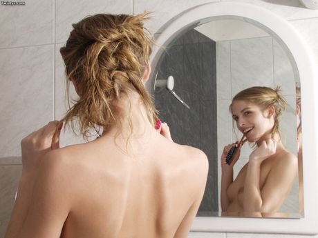 Blonde czech beauty Sharon Babe plays with her hair while naked in a shower