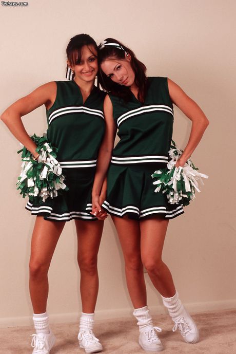 Gorgeous cheerleaders Charlie and Paulina get naked and spread their pussies