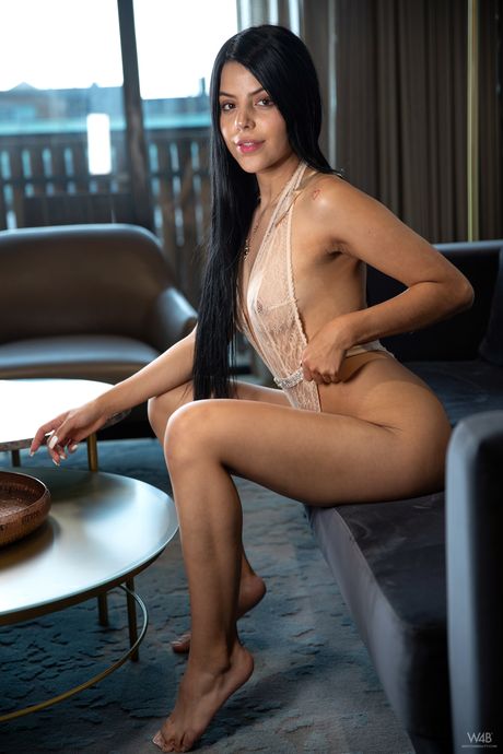 Delicate teen Salome shows her small tits and toys her pussy on a sofa