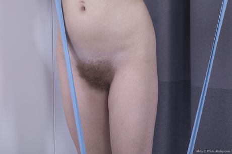 Nerdy russian teen Abby B strips her clothes and spreads her hairy pussy in a solo