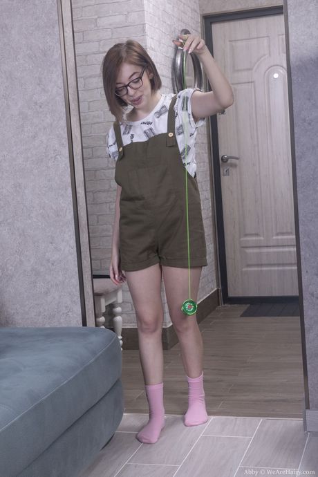 Nerdy russian teen Abby B strips and toys her hairy pussy in a solo