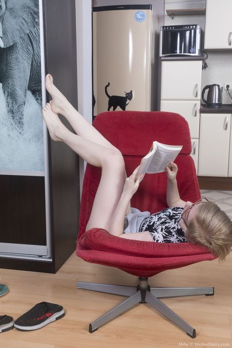 Slender russian blonde teen Abby B reveals her hairy pussy and rubs it