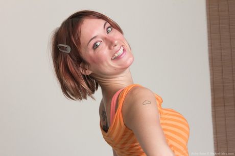 Glamour chick Ruby Ruthless strips and presents her hairy pussy in a solo