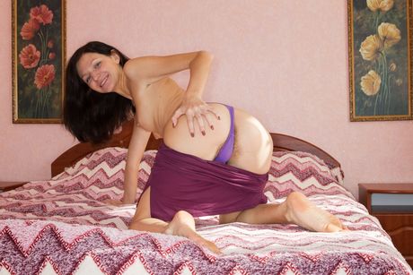 Alluring ukrainian girl Efina fingers her hairy pussy after getting naked